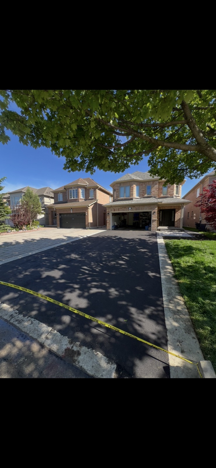 New asphalt driveway between two GTA homes